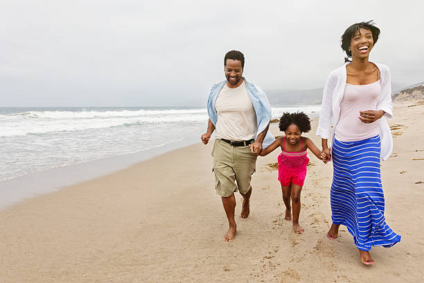 istock Family of Three Running on The Beach 179545461