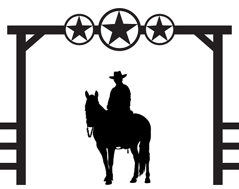 A cowboy is sitting astride his horse under a decorative ranch entrance gate