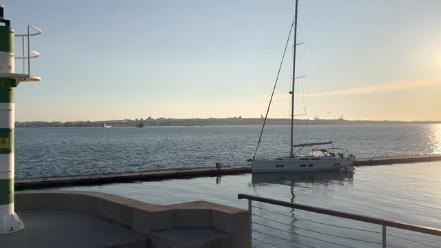 Yacht docked in marina of Setubal Portugal overlooking the Troia peninsula.