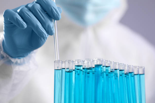 istock Scientist taking sample of light blue liquid on grey background, closeup 1795475031