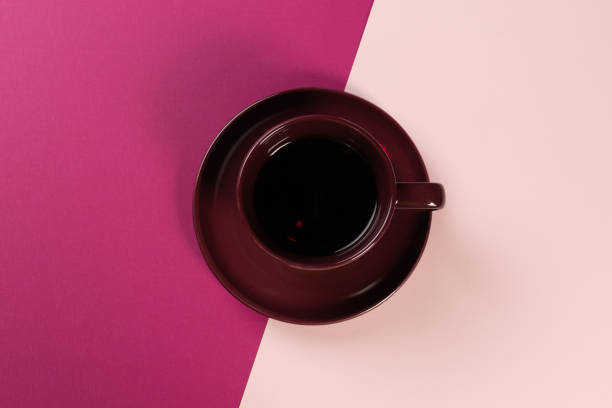 istock a cup of coffee on a light and dark pink background, 1795482111