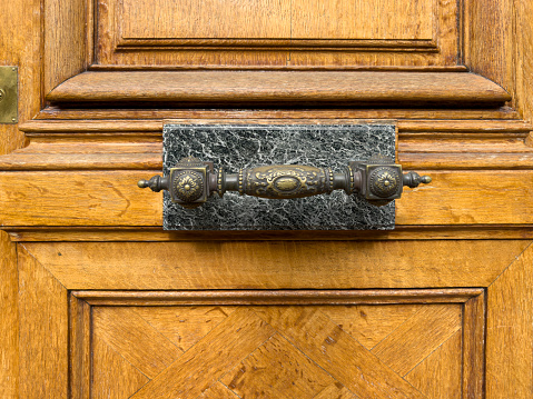 wooden door background with decorated brass