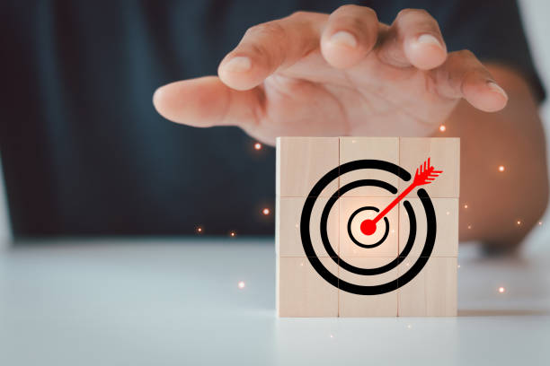 istock Business people hand protect virtual target board and arrow which print screen on wooden cube block. Business achievement goal and objective target concept. Creative set up business objectives target. 1795506184