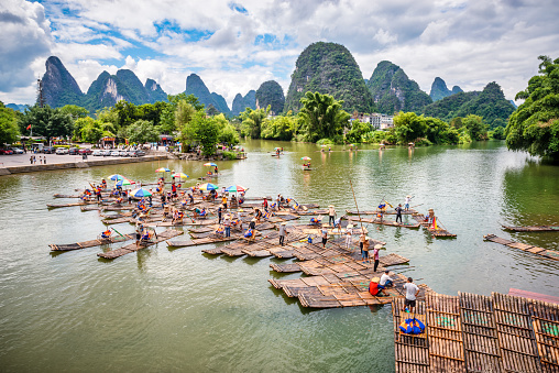 September 18, 2023 - Gaotianzhen, Yangshuo County, China:  Bamboo rafts with tourists on the Yulong River near Yangshuo, Guilin in Guangxi Province, China. This is the terminus for the bamboo raft ride along the river. Guilin, Guangxi Province