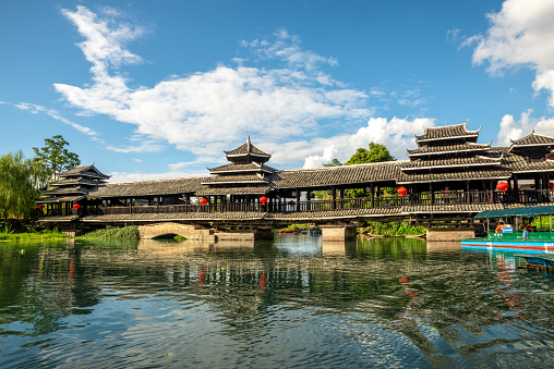 September 18, 2023 - Shiwai Toiyuan, Yangshuo County, China: Covered wood bridge at the Shangri-la Gardens, Yangshuo, Guilin