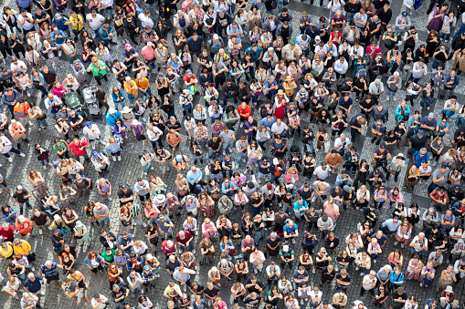Aerial top down view of a dense crowd of people in summer.
