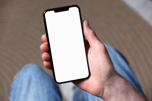 istock Man holding smartphone with blank screen indoors, closeup. Mockup for design 1795525827