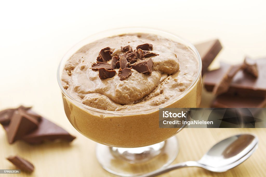 Chocolate mousse with chocolate Bowl of mousse au chocolat with chocolate pieces on wood. Blancmange Stock Photo