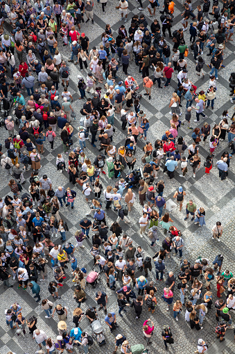 Aerial top down view of a dense crowd of people in summer.