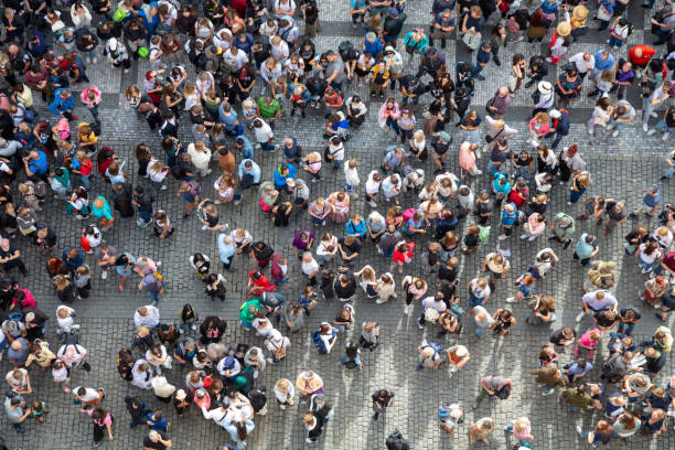 A dense crowd of people in summer viewed from directly above.