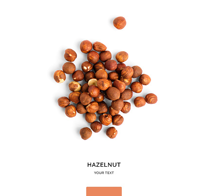 Creative layout made of hazelnut nuts on white background.Flat lay. Food concept.
