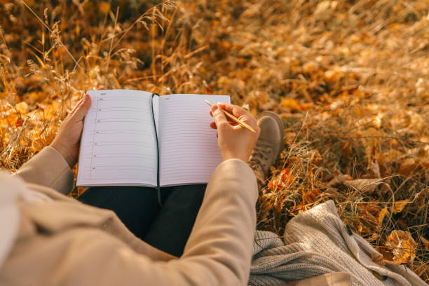 istock Girl with paper planner outdoors, autumn concept 1795572780