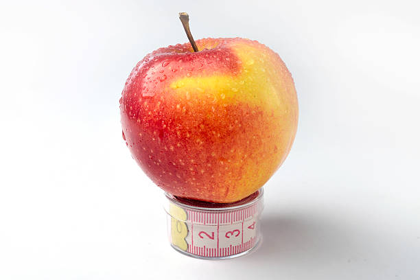 istock Apple with the tape line 179560152