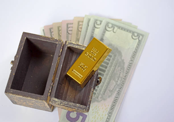 istock open chest, gold bar and dollars on a white background 1795605809