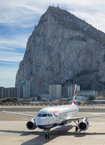 British Airways Airbus A320-232 on the apron at Gibraltar Aiport, with the Rock of Gibraltar behind.