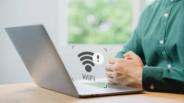 istock User using a laptop computer to connect to wifi but wifi not working or password is incorrect and waiting to loading digital data form website.Technology concept of wifi connected but no internet. 1795619026
