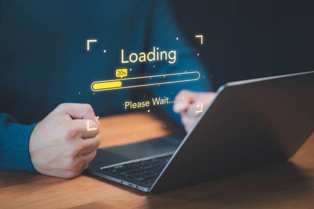 istock User use a laptop computer to download and update software with waiting to load digital file data from the website, and very slow internet from wifi. Concept of waiting for a load of loading symbol. 1795627835