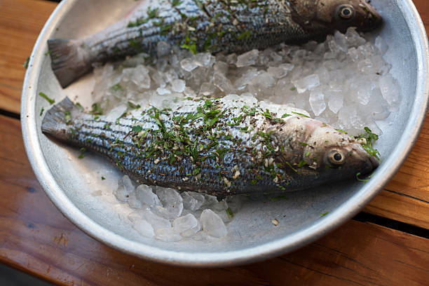 Whole fish seasoned over ice stock photo