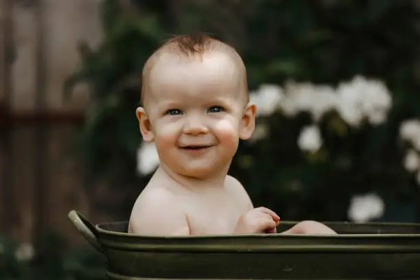 Photo of One Year Old Baby Boy in a Tub Outside