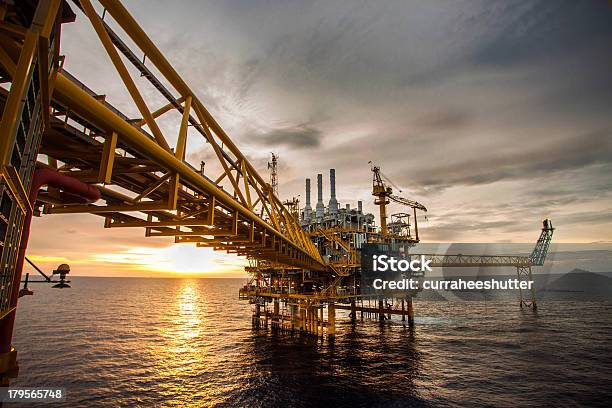 Oil And Gas Platform During Sunrise Or Sunset Stock Photo - Download Image Now - Offshore Platform, Crude Oil, Natural Gas