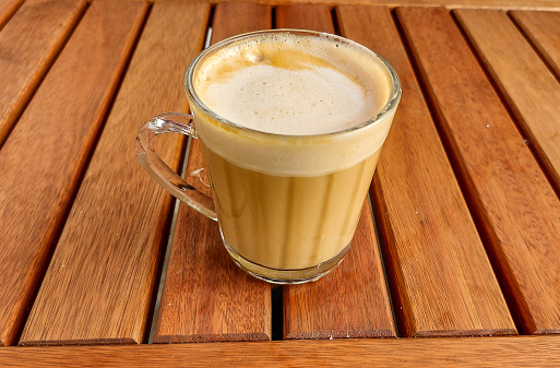 Coffee with milk in a glass mug