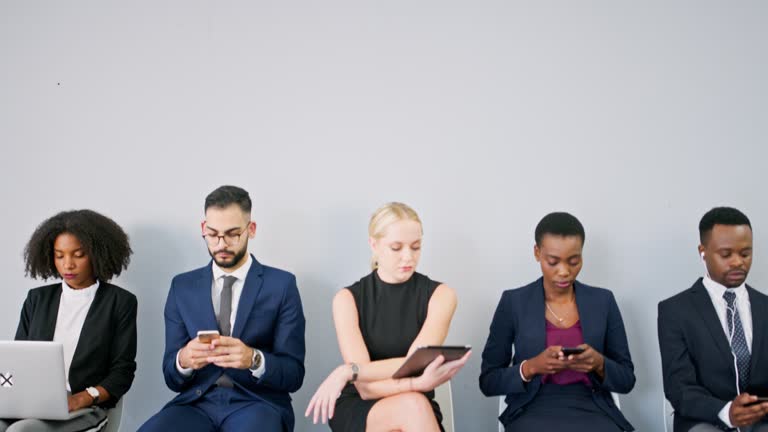 Human resources, interview and business people in line with tech, waiting to apply for a job opportunity. Hiring, recruitment and space with a candidate group in a workplace office for onboarding