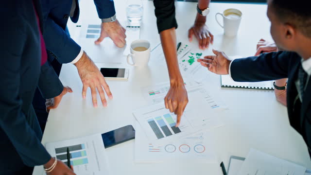 Business people, hands or documents in meeting and planning, data and strategy for brainstorming in office. Above, employees or collaboration or team with pointing at finance chart or sales analytics