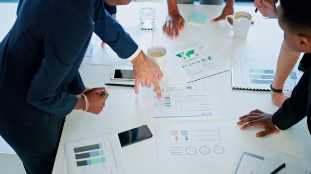 Business people, hands or documents in meeting and strategy, data and planning for brainstorming in office. Above, employees or collaboration or team with pointing at finance chart or sales analytics