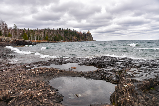 Split Rock Lighthouse and Lake Superior Coastline on North Shore on Cloudy Day with Strong Winds and Waves