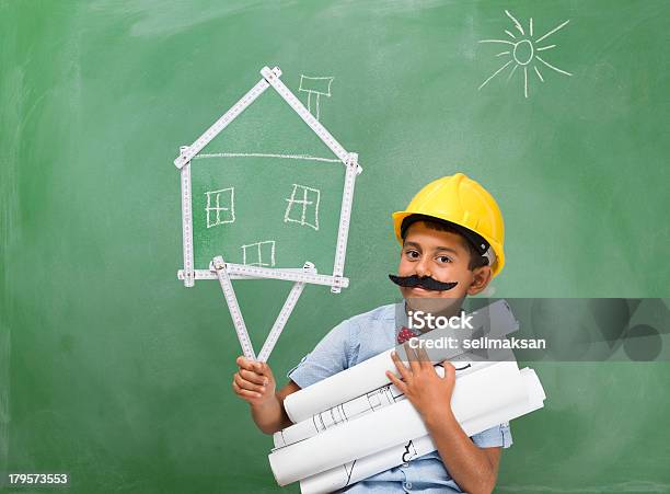 Foto de Pequena Com Capacete De Engenheiro E Bigode Segurando Esquemas e mais fotos de stock de 6-7 Anos