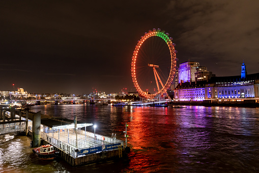 Illuminated London Eye and River Thames on a Rainy Autumn Night in London, October 2023, London, England