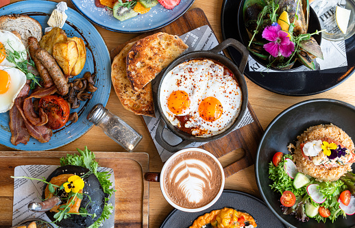 Table top view of breakfast food displayed on table.