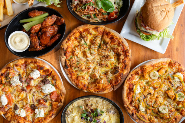 istock Variety of pizzas and burger on table. 1795745071