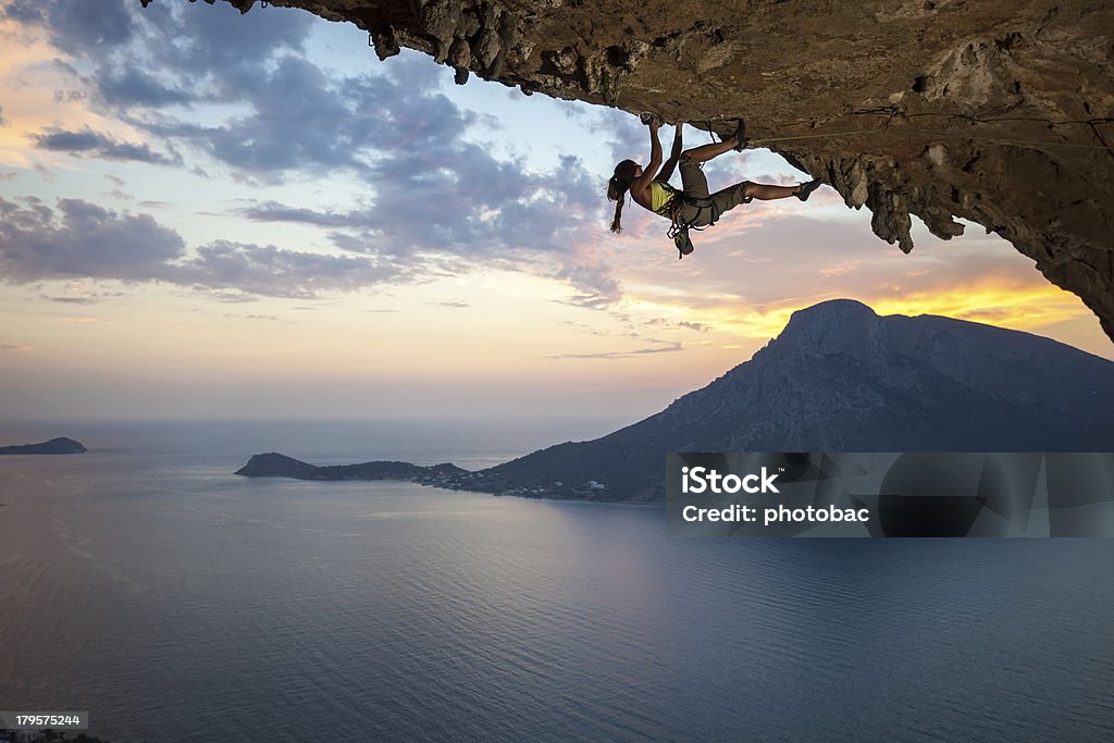 Young female rock climber at sunset Young female rock climber at sunset, Kalymnos Island, Greece Rock Climbing Stock Photo