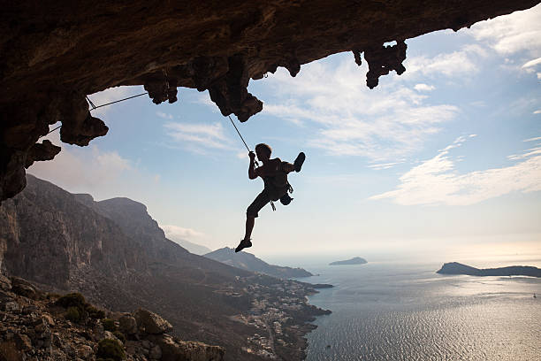 istock Silhouette of rock climber against sky 179575247
