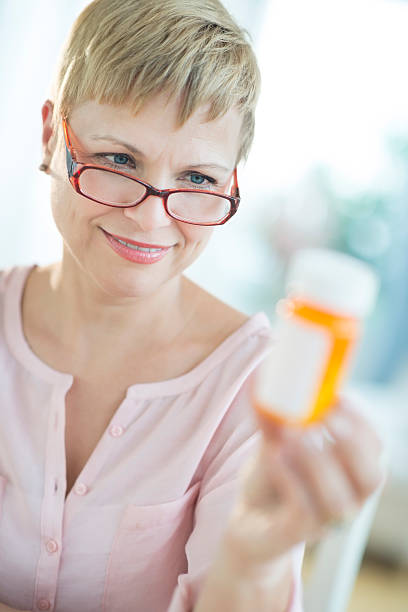 istock Woman Looking At Pill Bottle 179576137