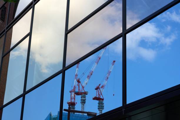 istock Crane reflected in the window of a skyscraper 1795764262