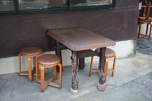 Small table and chairs on the street corner.