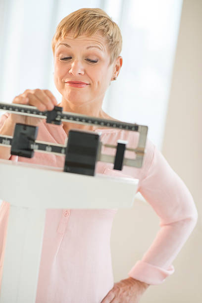 istock Woman Adjusting Sliding Weight Scale 179578352