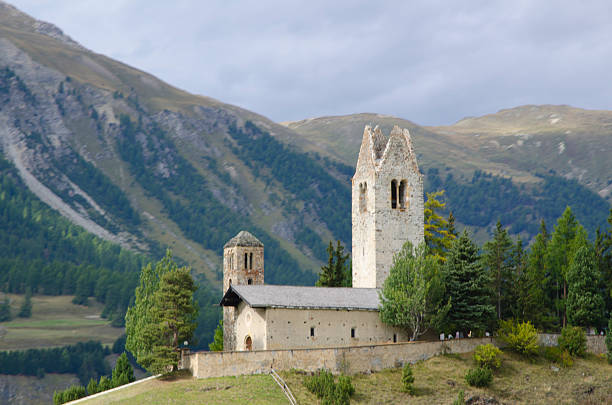 Church and mountain Church san giano celerina in samedan and mountain and green trees in st:Moritz switzerland samedan stock pictures, royalty-free photos & images