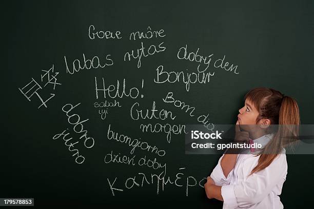 Small Girl Thinking About Foreign Phrases Stock Photo - Download Image Now - Non-Western Script, Learning, School Building