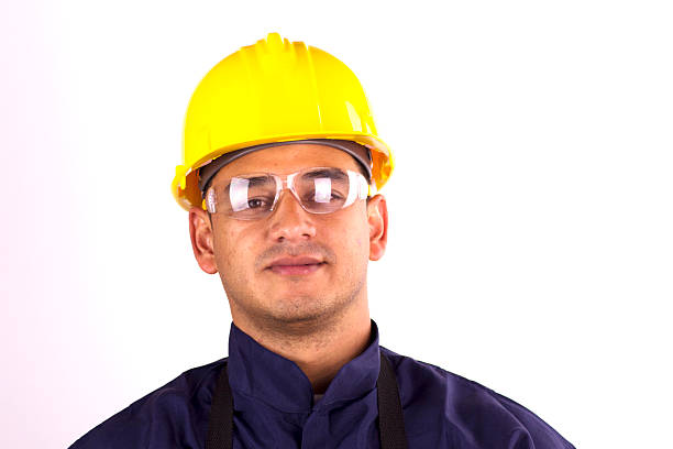 istock Worker in the foreground with glasses, helmet and uniform 179579981