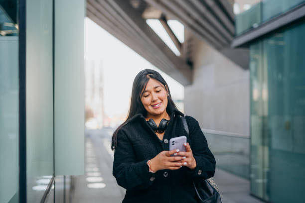 istock Young woman using smartphone on the way 1795814545