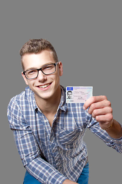 istock Young man showing off his driver license 179582289