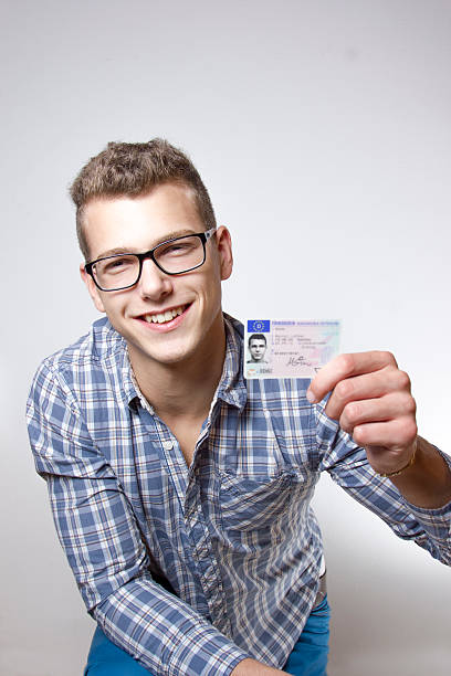 istock Young man showing off his driver license 179582353