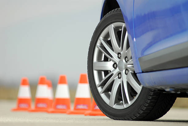 Sport car wheel with orange cones in background stock photo