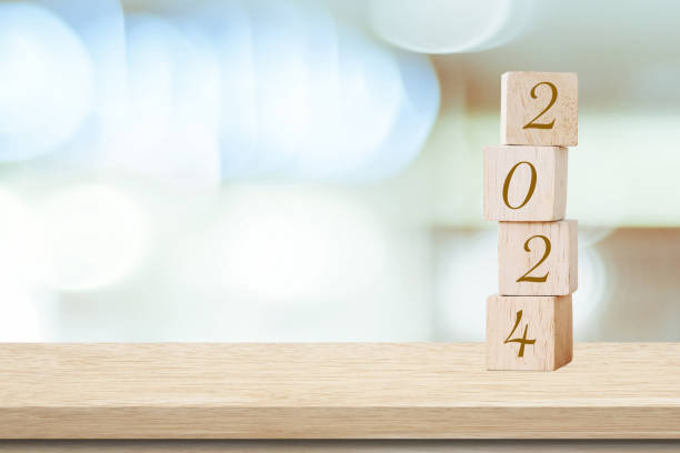 istock Happy New Year 2024 on wood cube block and blur abstract bokeh light with copy space background, Happy new year 2024 greeting card, banner 1795871571