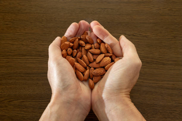 istock Lots of almonds in both hands 1795916853