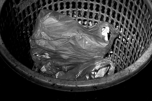 A pile of plastic waste in a waste basket.