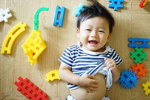 Baby laughing with belly button out